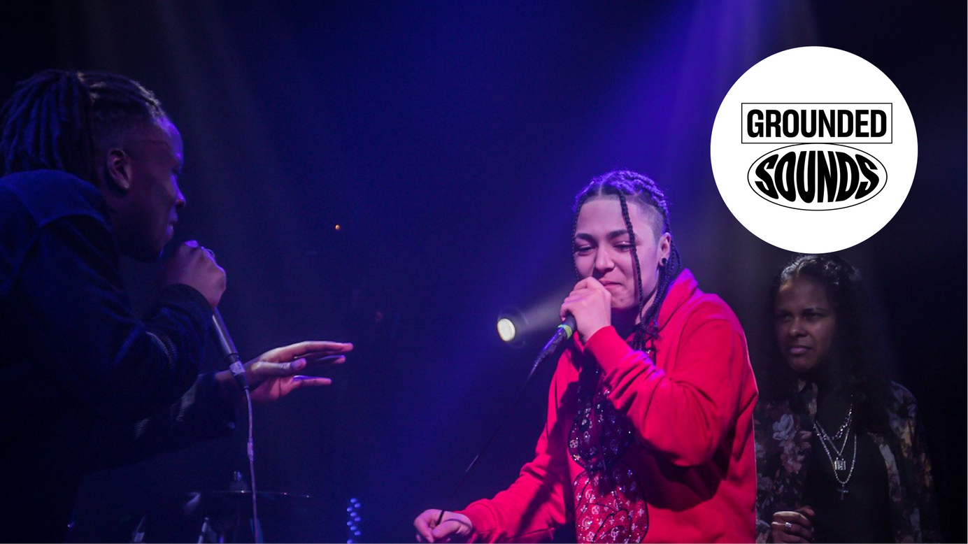 An image of two singers rapping and singing on stage as part of a School Ground Sounds production.