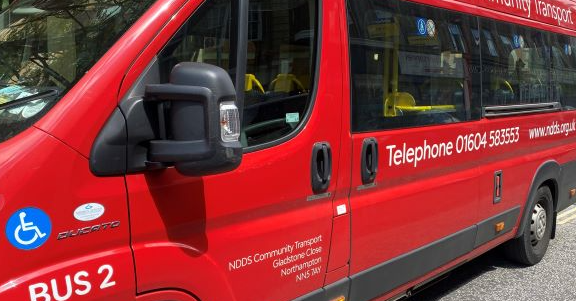 red bus used for community transport in Northampton